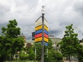 Street sign pole standing in the center of a city street in Frankfurt, Germany.