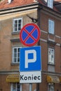 Street sign in polish and a brown building behind it in Warsaw, Poland