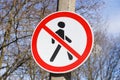 street sign. red circle with a human figure crossed by a red line. pedestrians are not allowed to pass