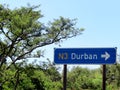 A street sign in South Africa showing drivers which way to turn if they want to go to the city of Durban.