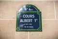 Street sign on a stone wall indicating the 8th arrondissement of Paris - Albert 1st course Royalty Free Stock Photo