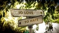 Street Sign LOVE versus TO HATE Royalty Free Stock Photo