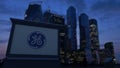 Street signage board with General Electric logo in the evening. Blurred business district skyscrapers background