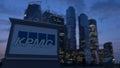 Street signage board with KPMG logo in the evening. Blurred business district skyscrapers background. Editorial 3