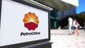 Street signage board with PetroChina logo. Blurred office center and walking people background. Editorial 3D rendering