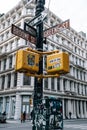 Street signs and traffic lights with stickers in SOHO New York City Royalty Free Stock Photo