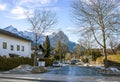 A street of a small Alpine town and ski resort with typical houses, road and mountains Royalty Free Stock Photo