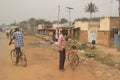 Street of a small Kenyan city bordering Uganda. Black men with bike and slums
