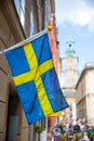 Street in Stockholm with swedish flag Royalty Free Stock Photo