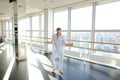 Street style dancer making hand movements near big window. Royalty Free Stock Photo