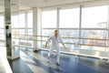 Street style dancer making hand movements near big window. Royalty Free Stock Photo