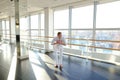 Street style dancer making hand movements near big window. Royalty Free Stock Photo