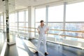 Street style dancer making hand movements near big window. Royalty Free Stock Photo