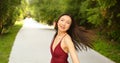 Street style outdoor portrait of Beautiful young Chinese Asian happy smiling woman walking outside sunny summer day Royalty Free Stock Photo