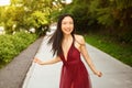 Street style outdoor portrait of Beautiful young Chinese Asian happy smiling woman walking outside sunny summer day Royalty Free Stock Photo