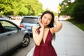 Street style outdoor portrait of Beautiful young Chinese Asian happy smiling woman walking outside sunny summer day Royalty Free Stock Photo