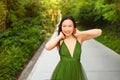 Street style outdoor portrait of Beautiful young Chinese Asian happy smiling woman walking outside sunny summer day Royalty Free Stock Photo