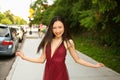 Street style outdoor portrait of Beautiful young Chinese Asian happy smiling woman walking outside sunny summer day Royalty Free Stock Photo