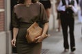 Street style outfit, fashionable woman wearing a gold large chain FF necklace from Fendi, a