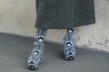 Street style outfit, fashionable woman wearing long grey coat and patterned-jacquard platform