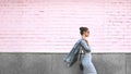 Street Style Shoot Woman on Pink Wall. Swag Girl Wearing Jeans Jacket, grey Dress, Sunglass. Fashion Lifestyle Outdoor