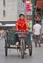 Street sweeper on an an old tricycle in Beijing, China