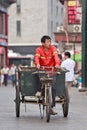 Street sweeper on an old tricycle in Beijing, China