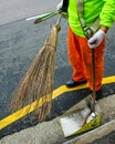 Street sweeper in Singapore uses traditional broom