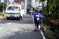 Street sweeper sweeps dirt and other debris after a night of rain and wind caused by typhoon Ambo