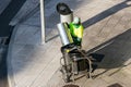 Street sweeper unloading a garbage can on pushing a cart on sidewalk