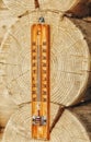 Street thermometer fixed on the end logs of the house