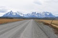 Street to Torres del Paine National Park in Chile, Patagonia with snow covered mountains in background Royalty Free Stock Photo