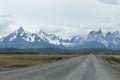 Street to Torres del Paine National Park in Chile, Patagonia with snow covered mountains in background Royalty Free Stock Photo