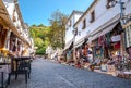 Street with tourists and souvenir shops in Gjirokaster, Albania