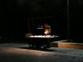 Street seller with stall at night in Athens, Greece