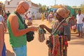 Street trading. Bald Tourist European buys beads or jewelry from an Indian seller. The seller on the street sells his goods.