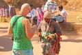 Street trading. Bald Tourist European buys beads or jewelry from an Indian seller. The seller on the street sells his goods.