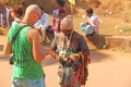 Street trading. Bald Tourist European buys beads or jewelry from an Indian seller. The seller on the street sells his goods.