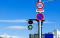 Street traffic light crosswalk sign against blue sky