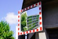 Street traffic red white convex mirror in road safety concept in city center