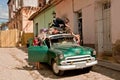A street in Trinidad, Cuba with a man playing Royalty Free Stock Photo