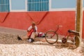 A street in Trinidad, Cuba with a man playing Royalty Free Stock Photo