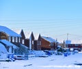 Street with two-storey houses, all in the snow. Royalty Free Stock Photo