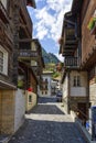 Street and typical wooden chalets in Zermatt village, Switzerland