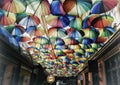 Street with umbrellas with rainbow color