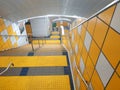 Street urban staircase with yellow illumination leading underground