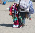 street vendor with beach towels that sells his wares on the beac