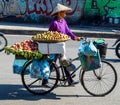 Street vendor on bicycle bring goods to food market in the Old Quarter of Hanoi, Vietnam