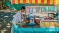 A street vendor in Cambodia preparing sugarcane juice.