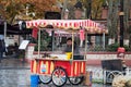 Street vendor with a colorful cart selling fresh